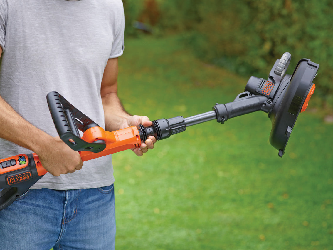 Coupe-bordure marque Black+Decker, outil de jardinage orange et noir.