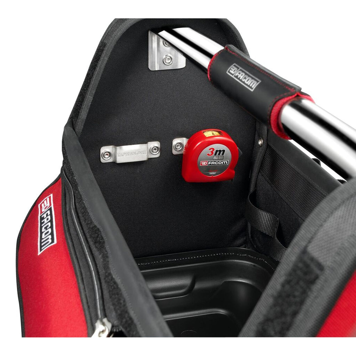 Mètre ruban Facom rouge, outil de mesure placé dans un sac à outils noir et rouge.