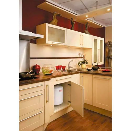 Chauffe-eau blanc Atlantic installé sous évier dans une cuisine moderne beige.