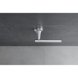 Siphon lavabo Grohe chromé, accessoire sanitaire design et moderne sur carrelage gris.