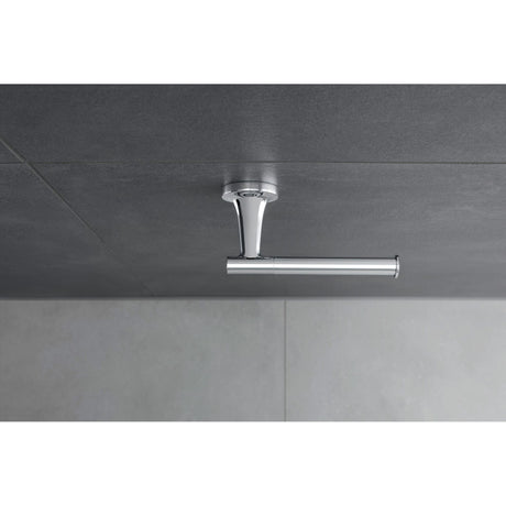 Siphon lavabo Grohe chromé, accessoire sanitaire design et moderne sur carrelage gris.
