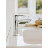 Mitigeur lavabo chromé Grohe moderne, couleur argent, installé sur un évier blanc.