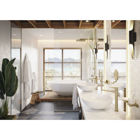 Salle de bain moderne avec robinets dorés Grohe, vasques rondes blanches, baignoire blanche.