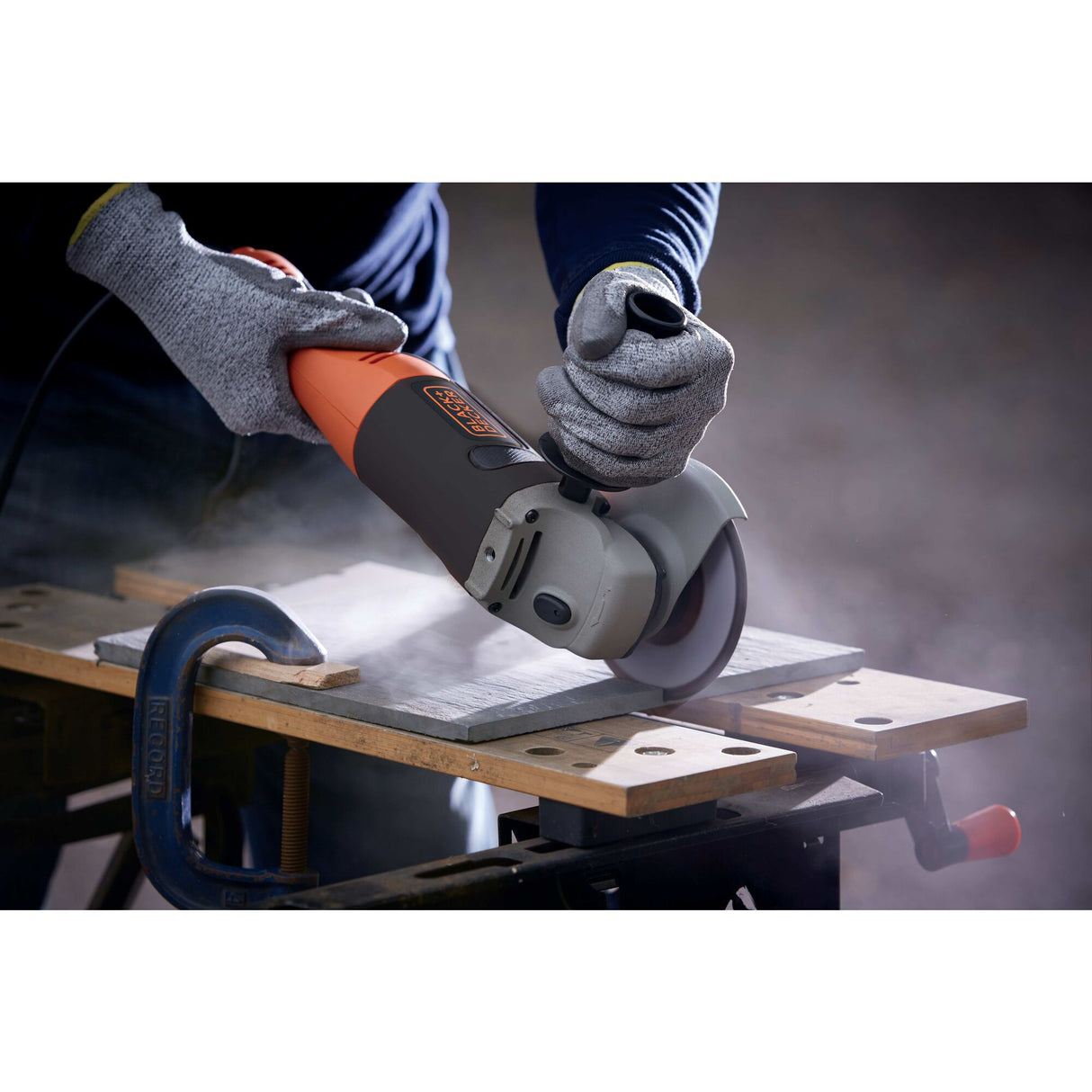 Meuleuse d’angle Black+Decker, outil électroportatif orange et noir, en action