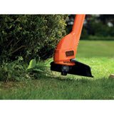Coupe-bordures Black+Decker, outil de jardinage orange utilisé sur du gazon