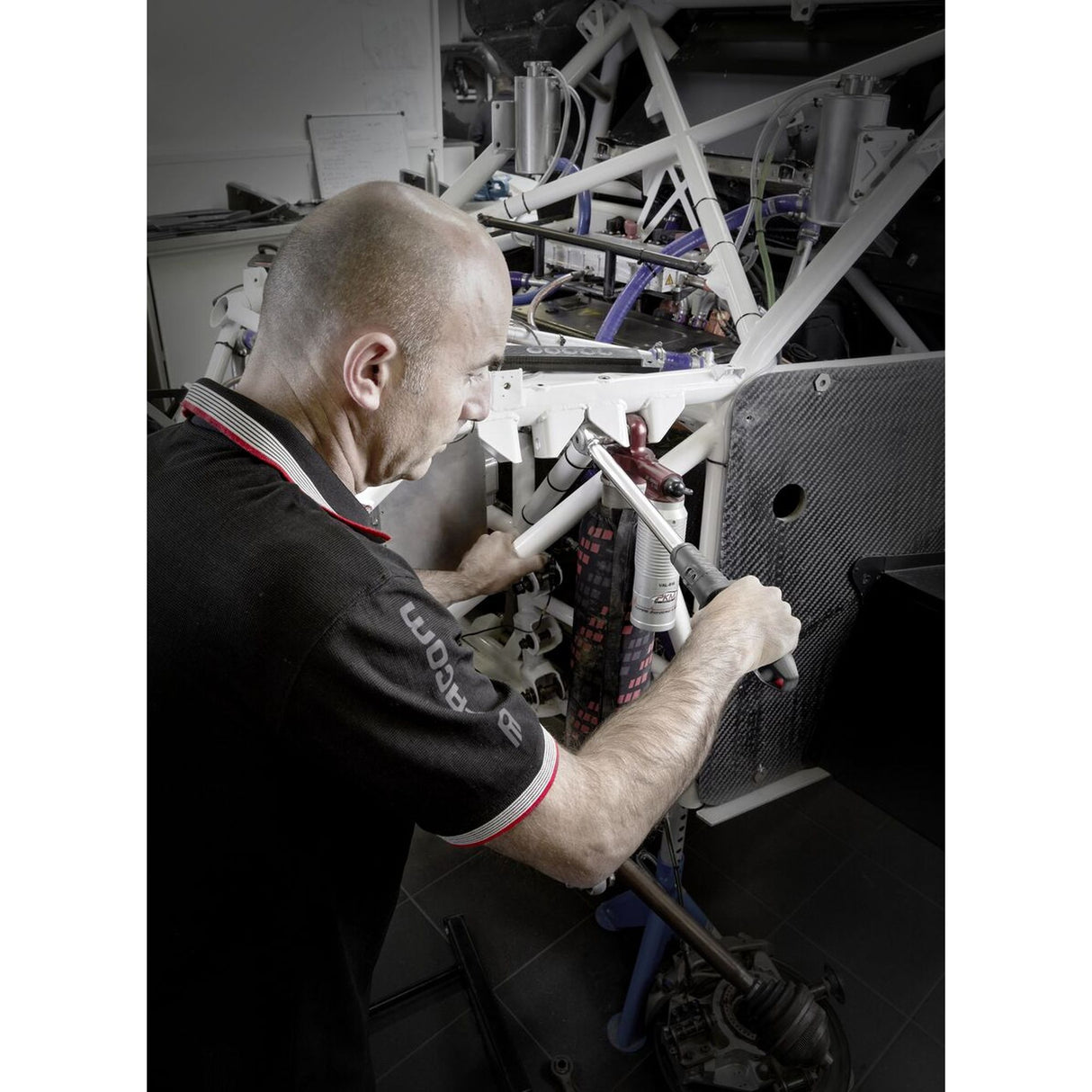 Outillage Facom, clé grise utilisée pour réparer une structure métallique blanche.