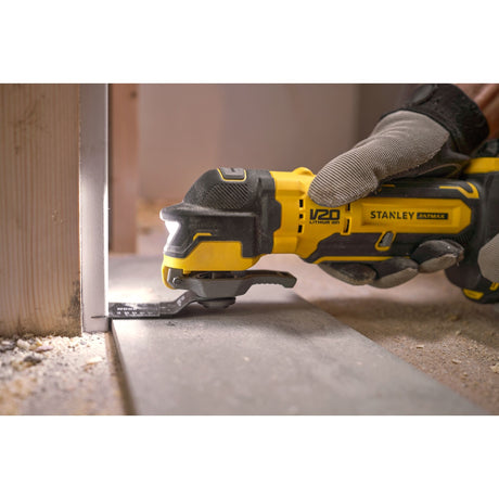 Outil multifonction Stanley Fatmax, électroportatif, couleur jaune et noir, en action sur sol.