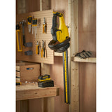 Taille-haie jaune et noir Stanley, outil électroportatif accroché au mur d'un atelier.