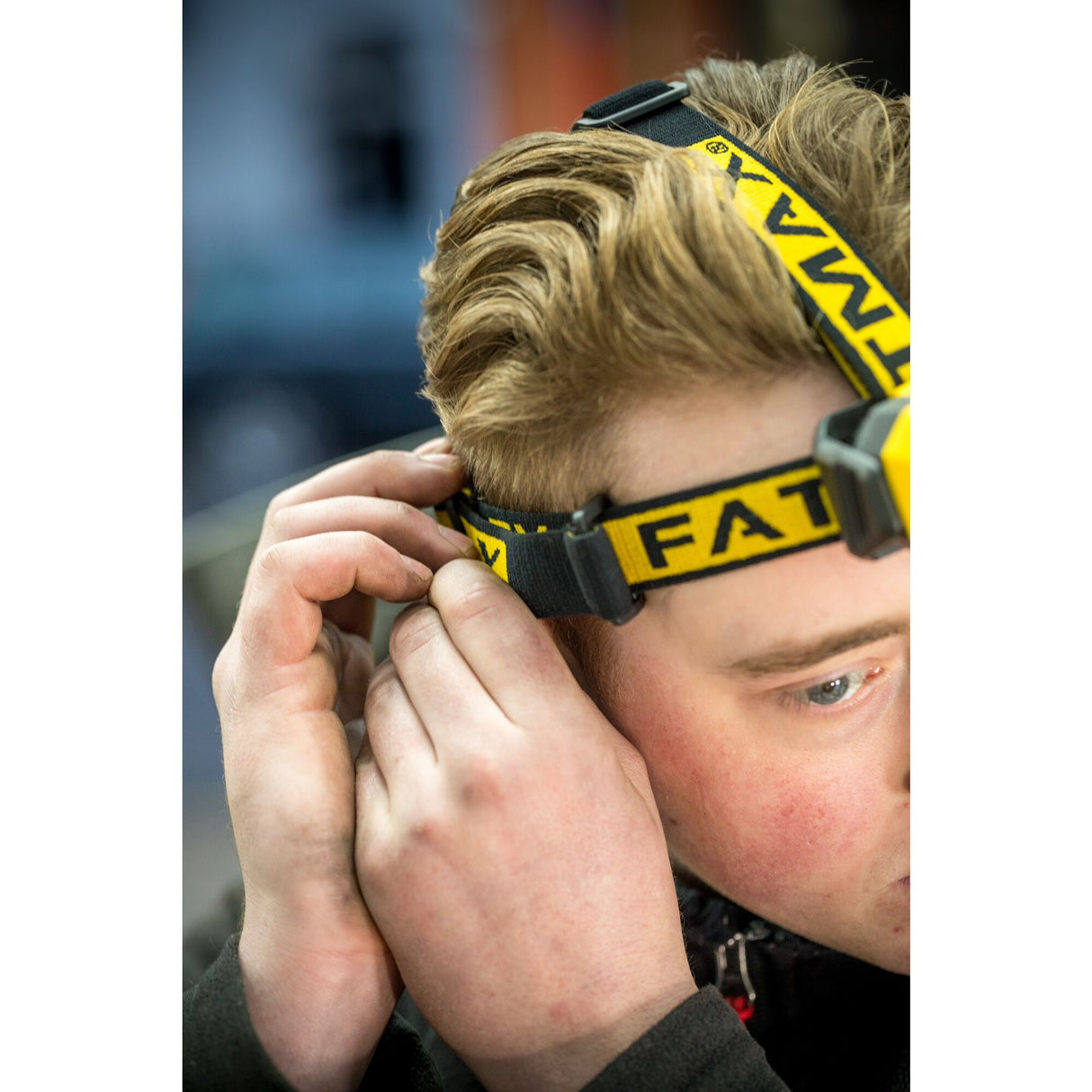 Lampe frontale Stanley FATMAX, jaune et noire, portée par un homme