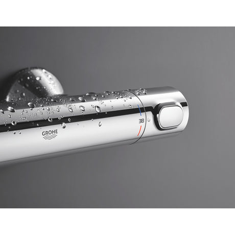 Mitigeur thermostatique Grohe, chrome, robinet de douche avec gouttes d'eau.