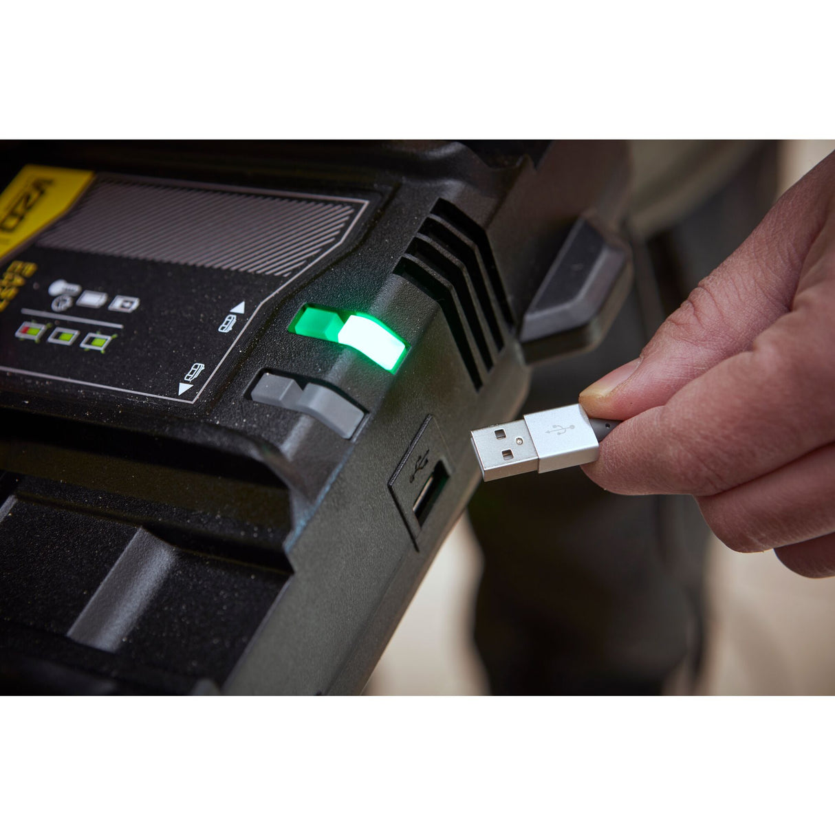 Chargeur Facom noir avec port USB, voyant vert, main branchant un câble USB