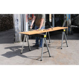 Tréteaux Stanley, table de travail pliable, couleur noire et jaune, utilisés en extérieur.