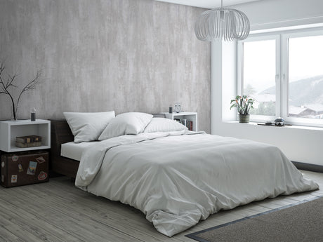 Panneau mural VIPANEL, type décoratif, couleur béton gris, posé dans une chambre moderne.